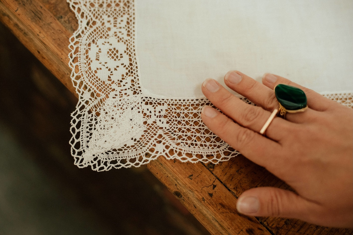 detailed photo of a hand holding a moravian traditional hand woven lace 